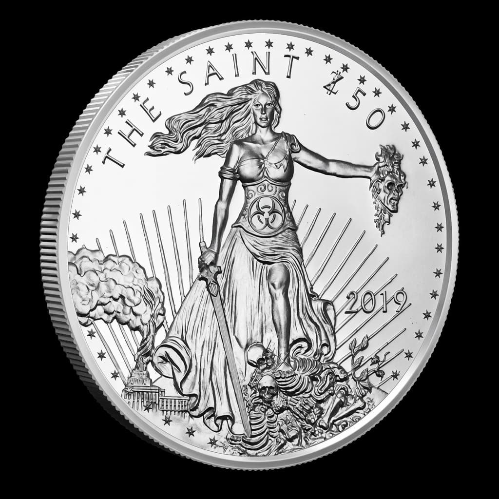1 oz Zombucks The Saint silver round showing Liberty with a sword and severed zombie head over a field of skeletons